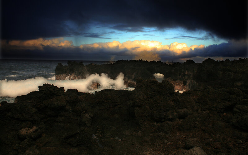Stormy waves crash on volcanic rocks