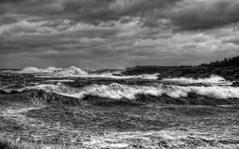 Stormy waves crashing on rocky shore