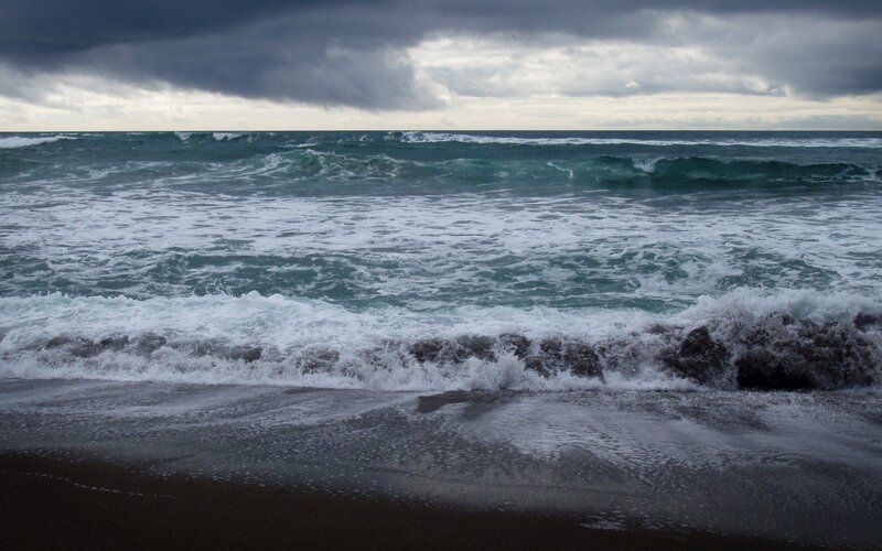 Stormy waves on a dark beach