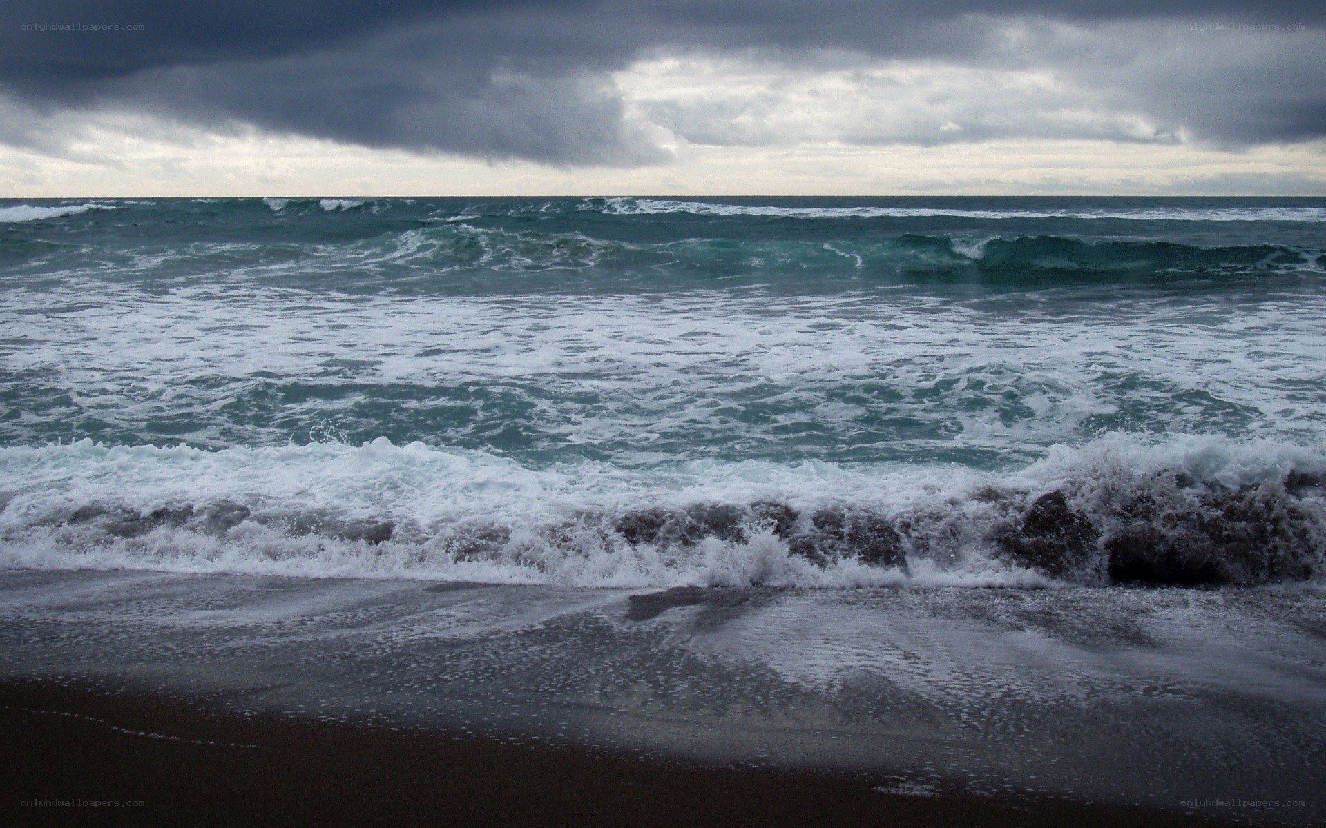 Stormy waves on a dark beach