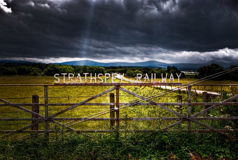Strathspey Railway sign under stormy sky