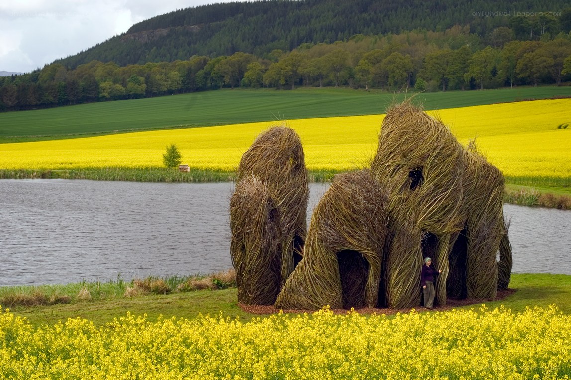 Straw sculptures by a lake