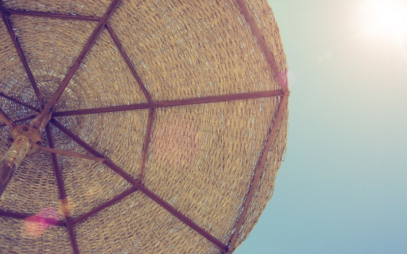 straw umbrella under sun