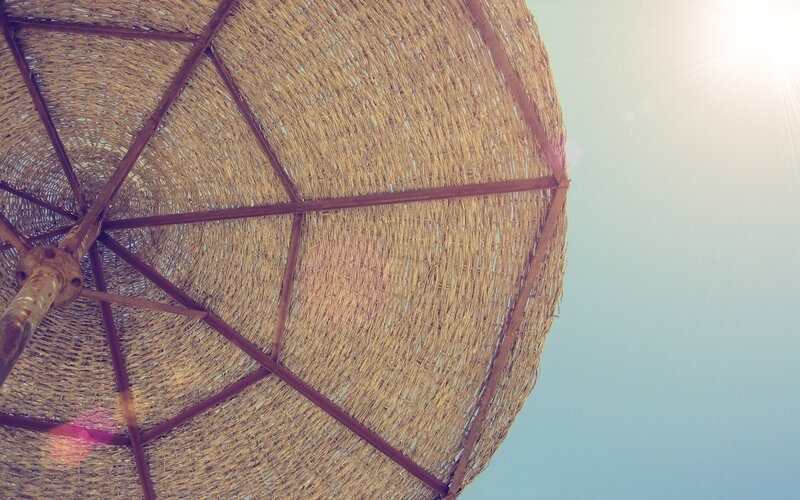 Straw umbrella under sun