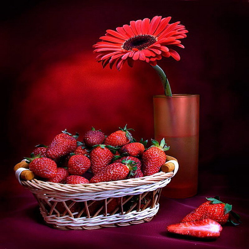 Strawberries and a red flower