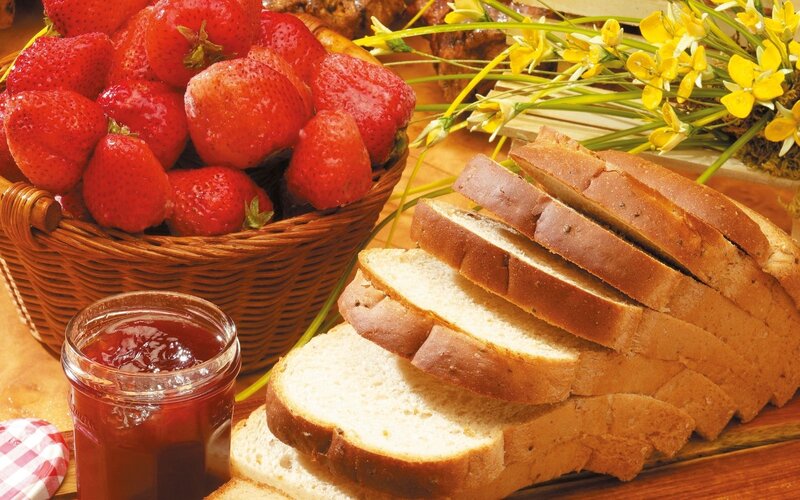 Strawberries and bread on table