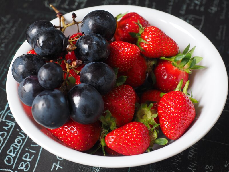 strawberries and grapes in a bowl