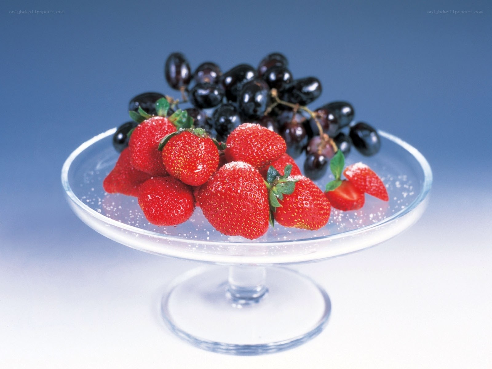 strawberries and grapes on glass stand