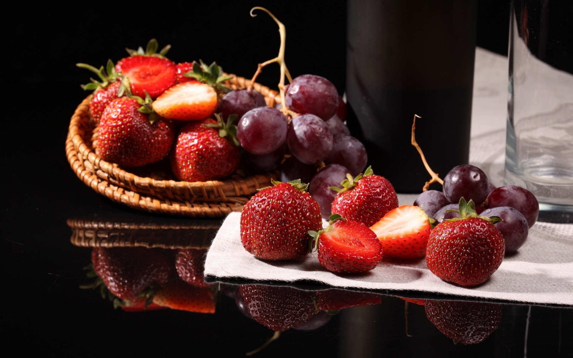 Strawberries and grapes on table