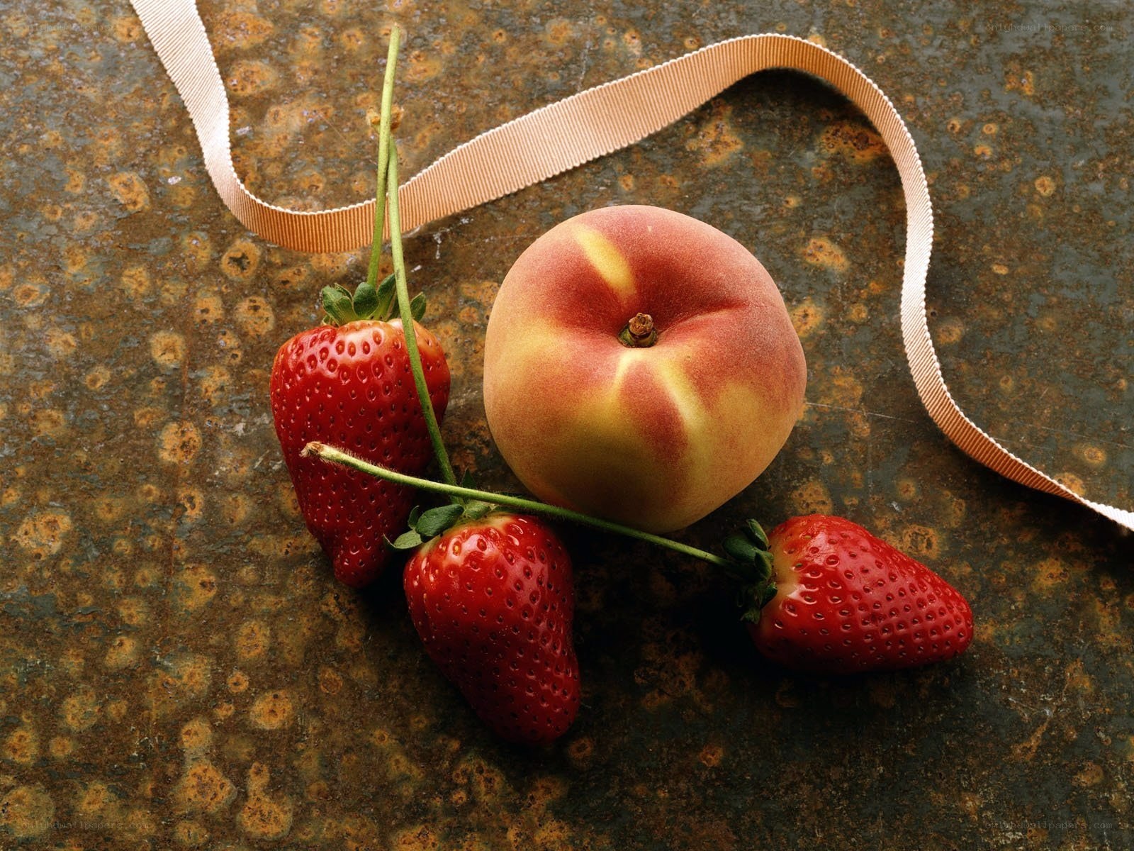 strawberries and peach on metal