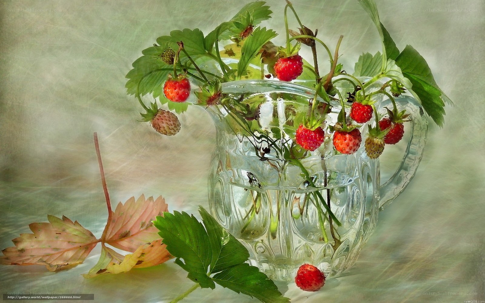 Strawberries in a glass pitcher