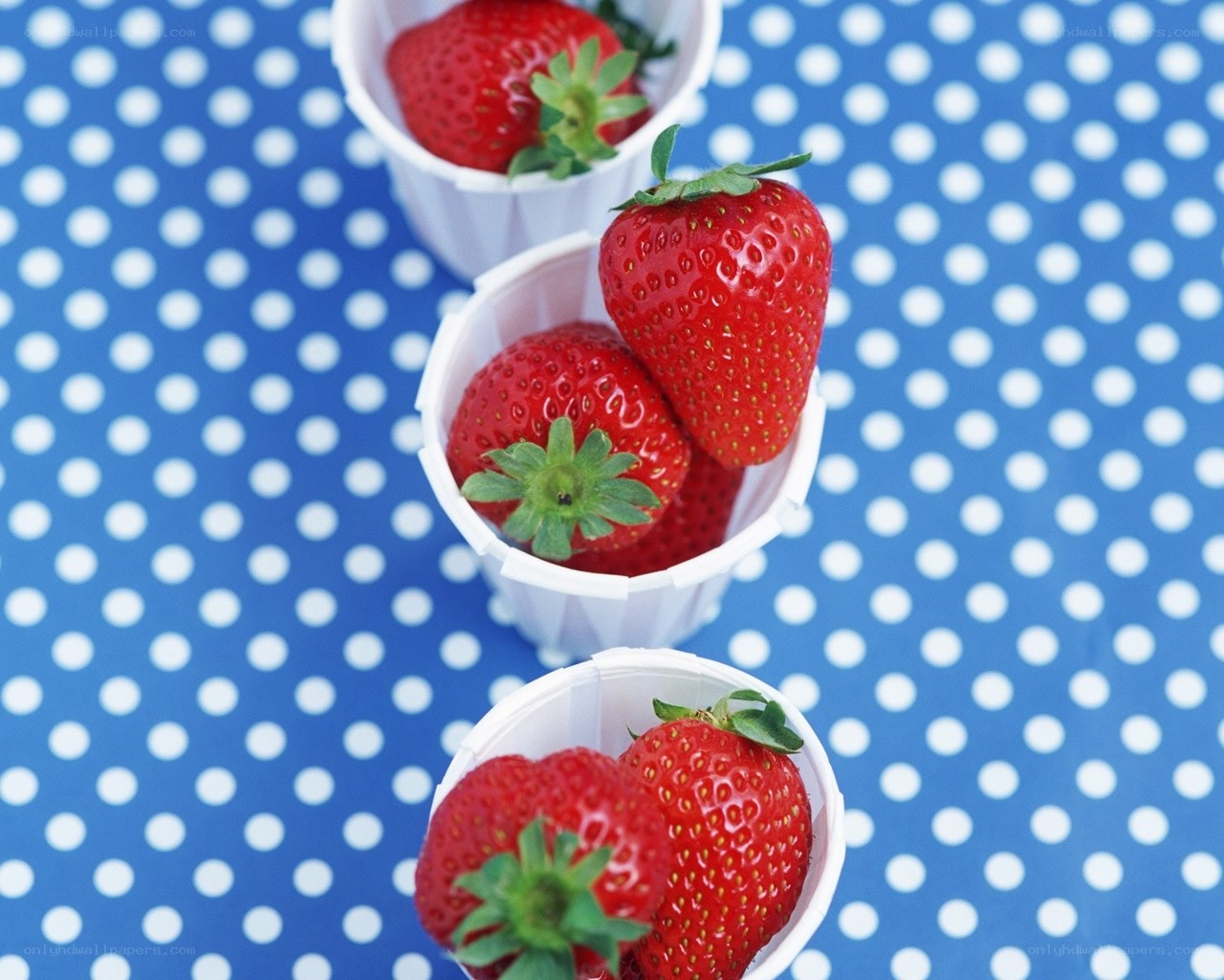 strawberries in paper cups