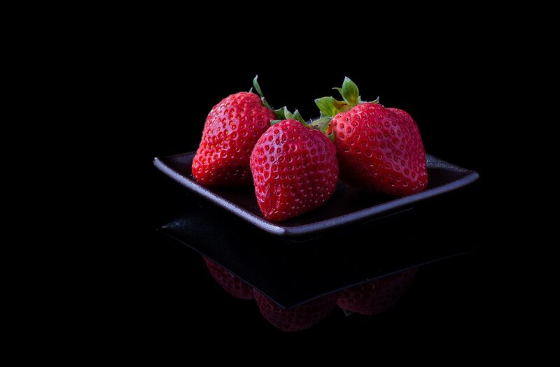 Strawberries on a black plate