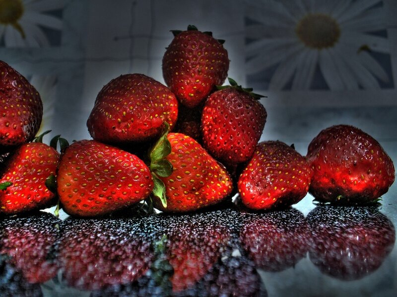 Strawberries on a reflective surface