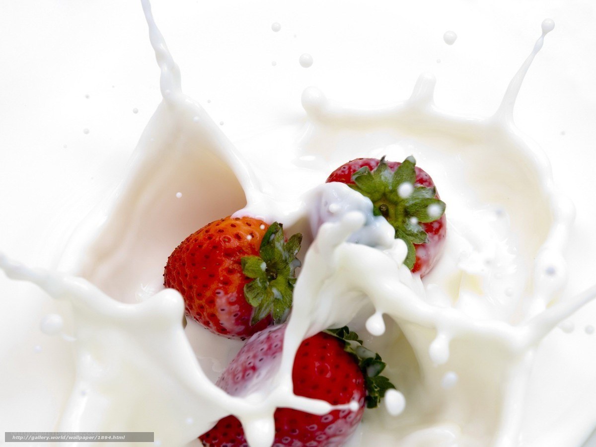 strawberries splashing in milk