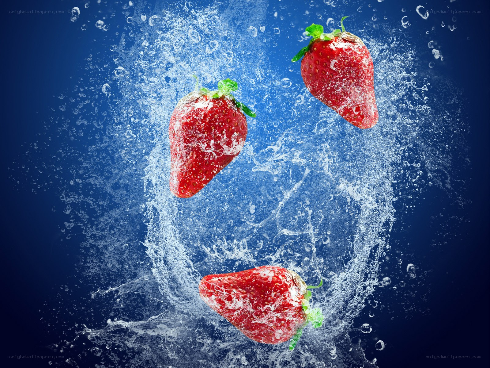 strawberries splashing in water