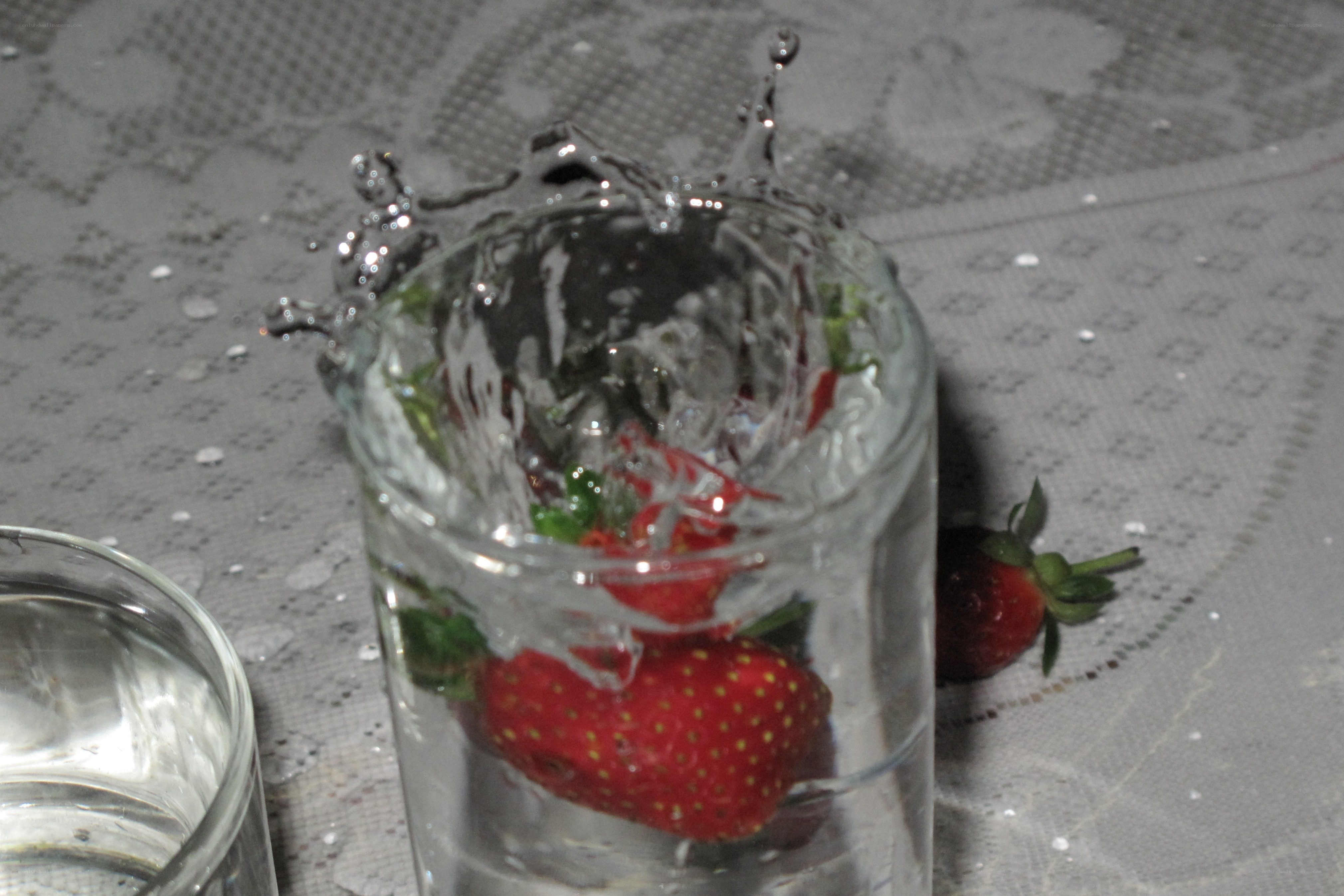 strawberries splashing in water