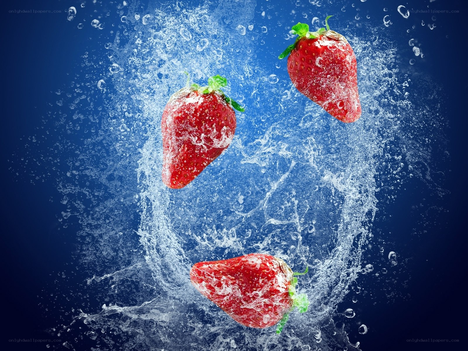 strawberries splashing in water
