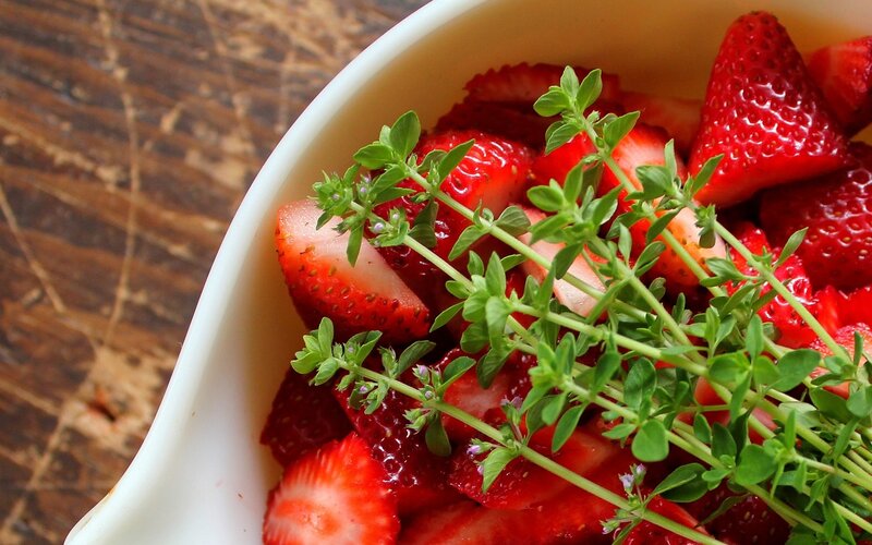 Strawberries with herbs in a bowl