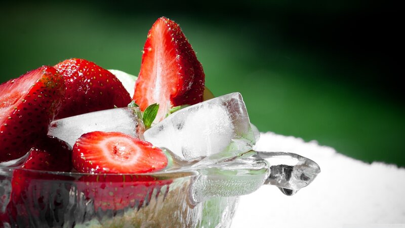 Strawberries with ice in a glass bowl