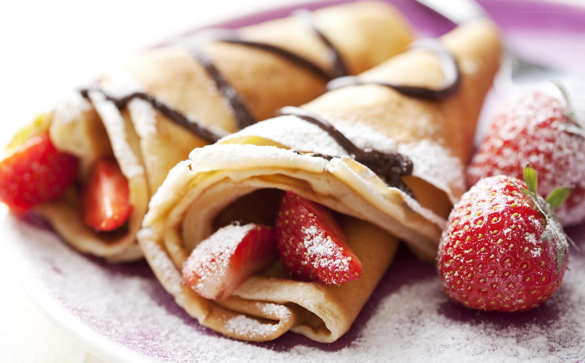 strawberry crepes with chocolate drizzle