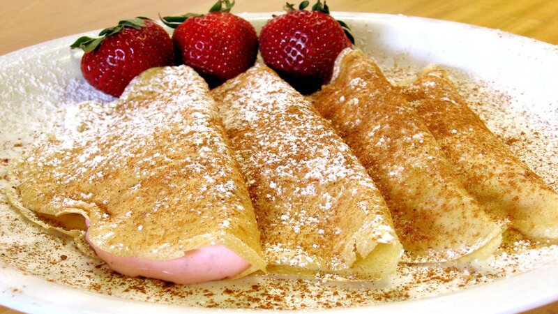 strawberry crepes with powdered sugar
