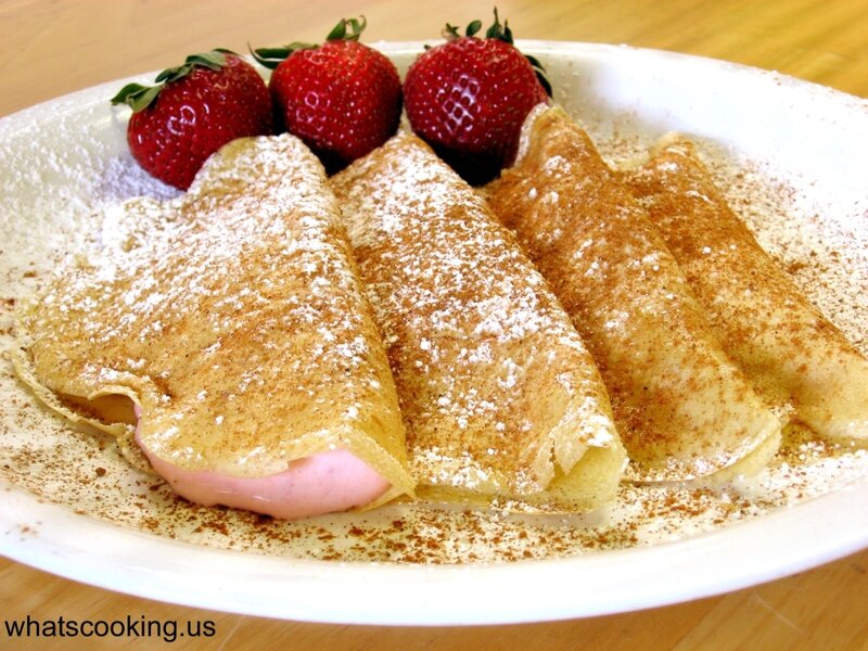 strawberry crepes with powdered sugar