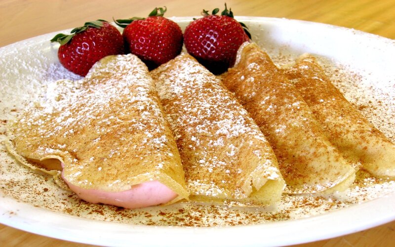 strawberry crepes with powdered sugar