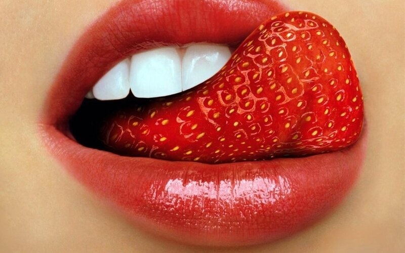 strawberry in mouth close-up
