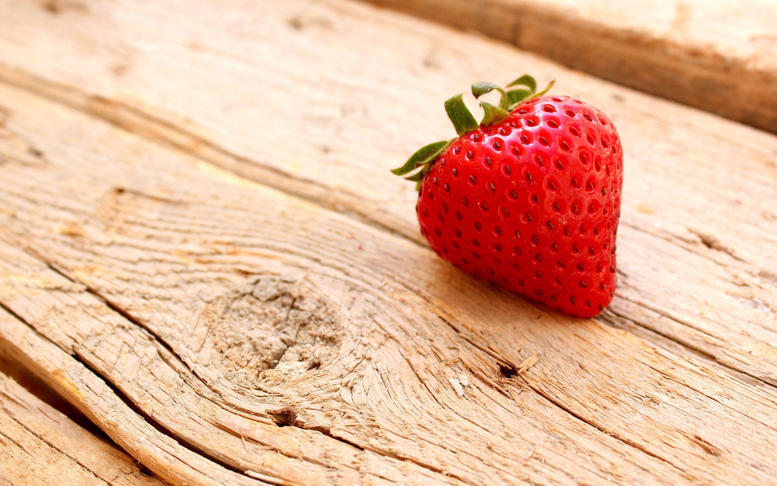 strawberry on wooden surface