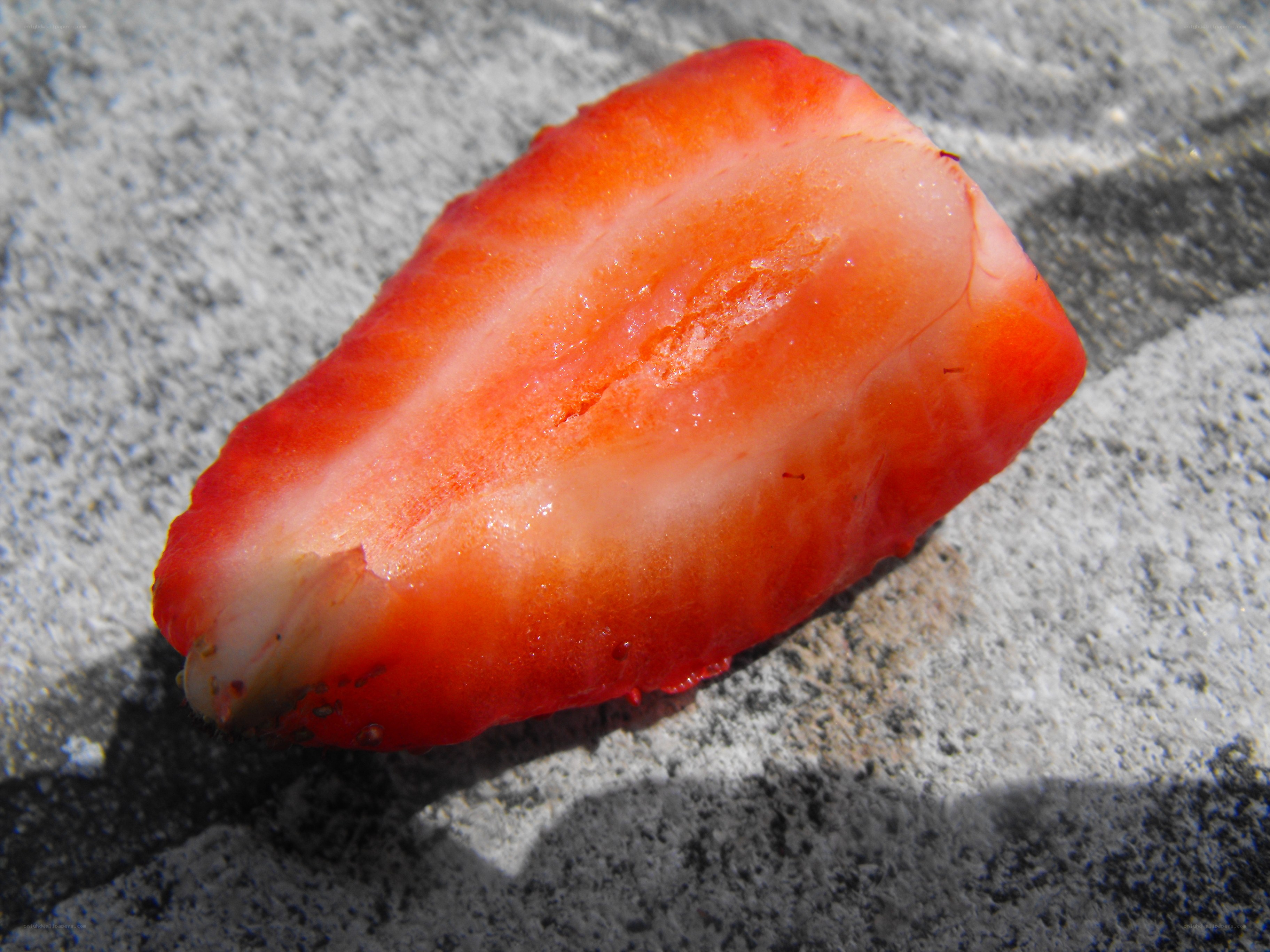 Strawberry slice on stone