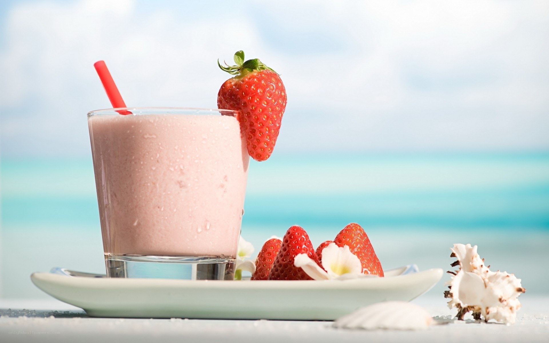 Strawberry smoothie on beach