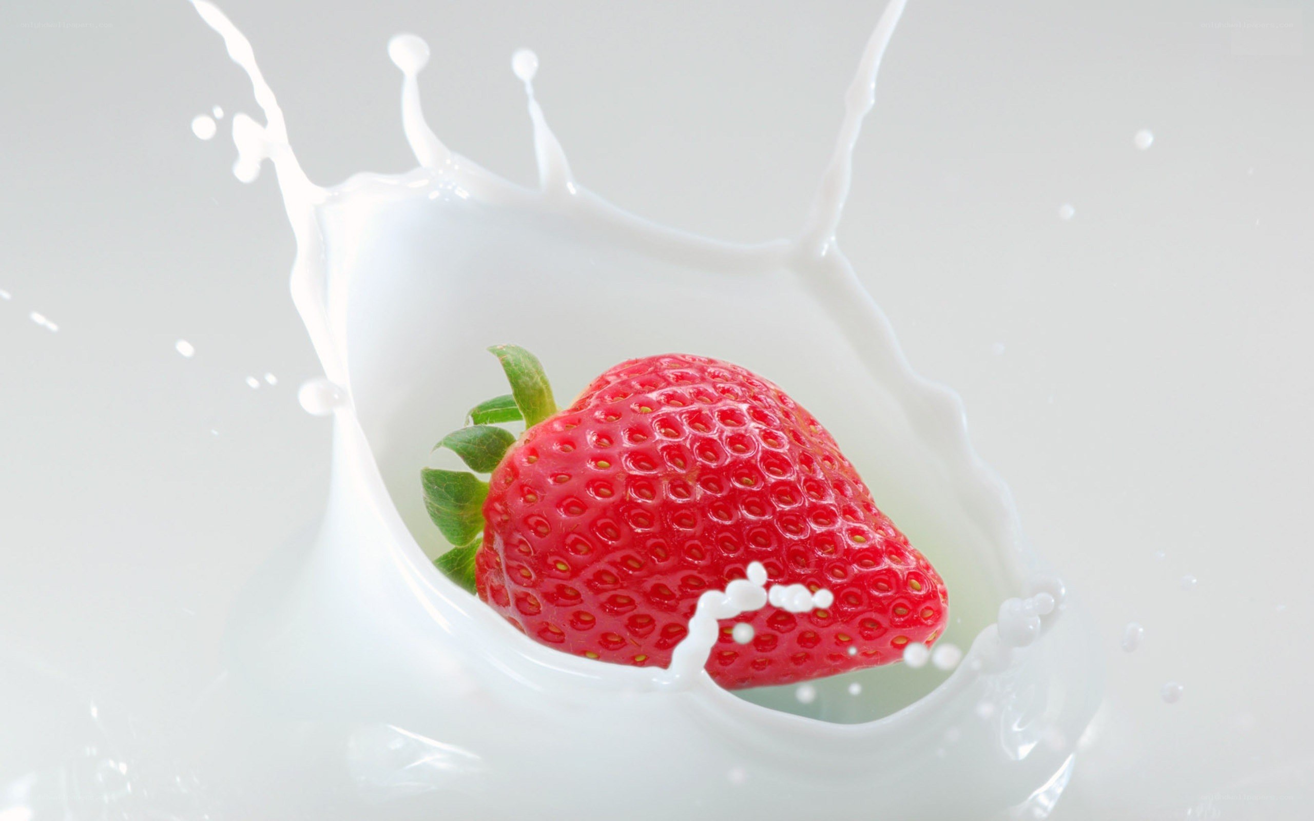 strawberry splashing in milk
