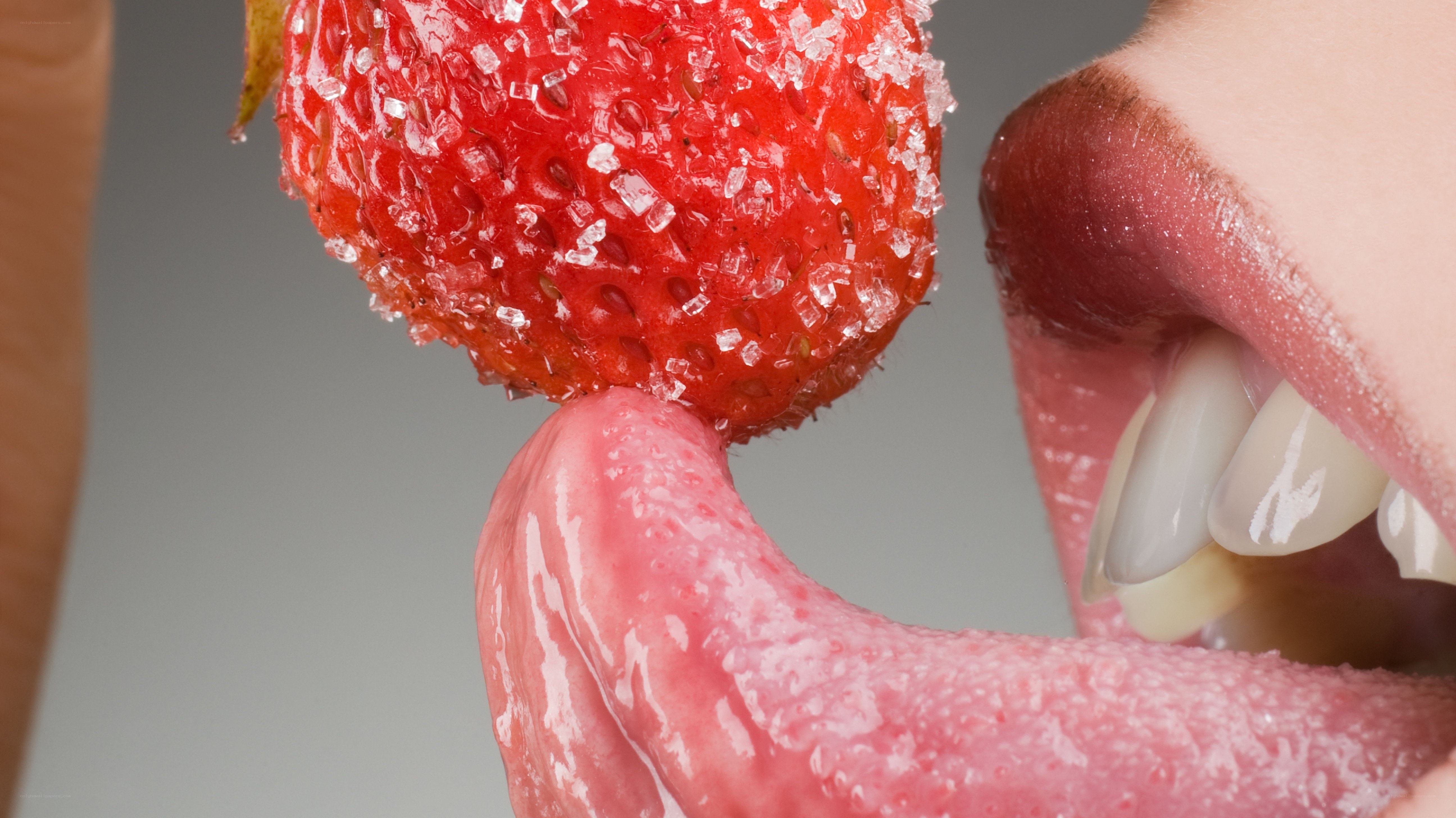 strawberry with sugar and tongue