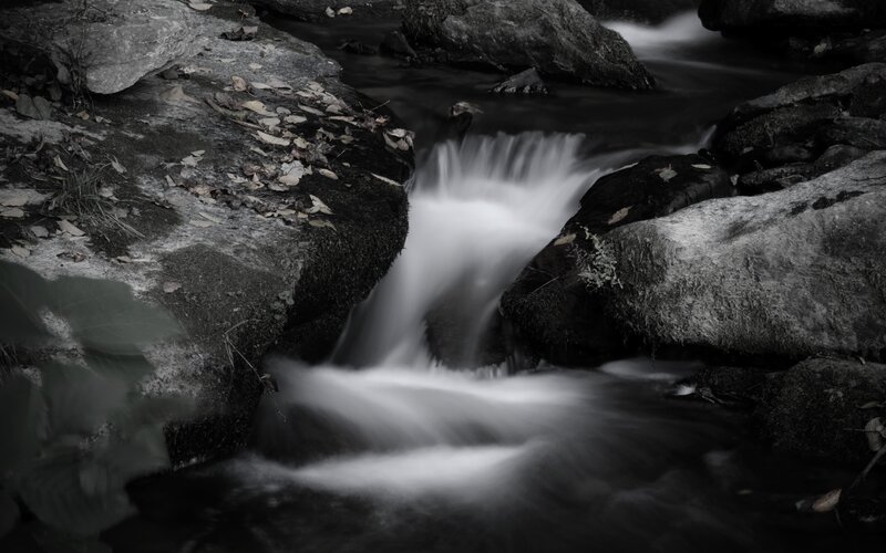 Stream Flowing over Rocks — Black