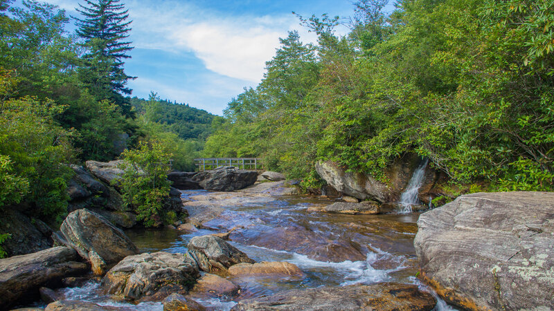 Stream Flowing over Rocks — Green, Serene, Afternoon, Photograph, Trees, Bridge, Mountain