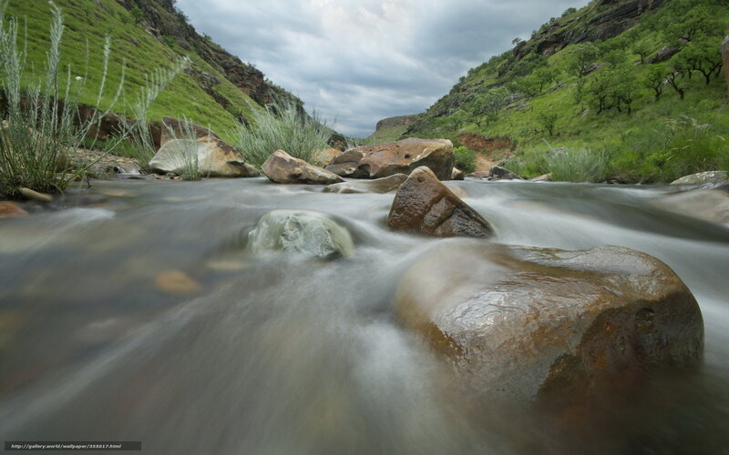 Stream flowing through a green valley