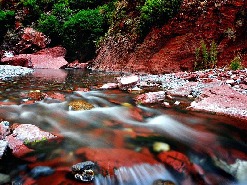 Stream Flowing Through Red Rocks — Serene