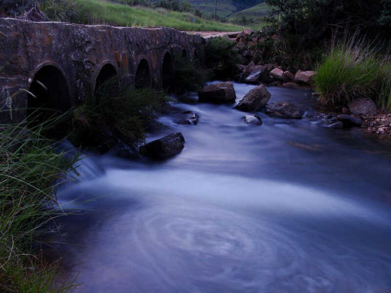 Stream under stone bridge