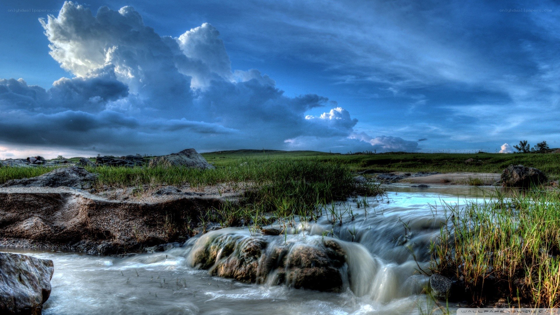 Stream under stormy sky