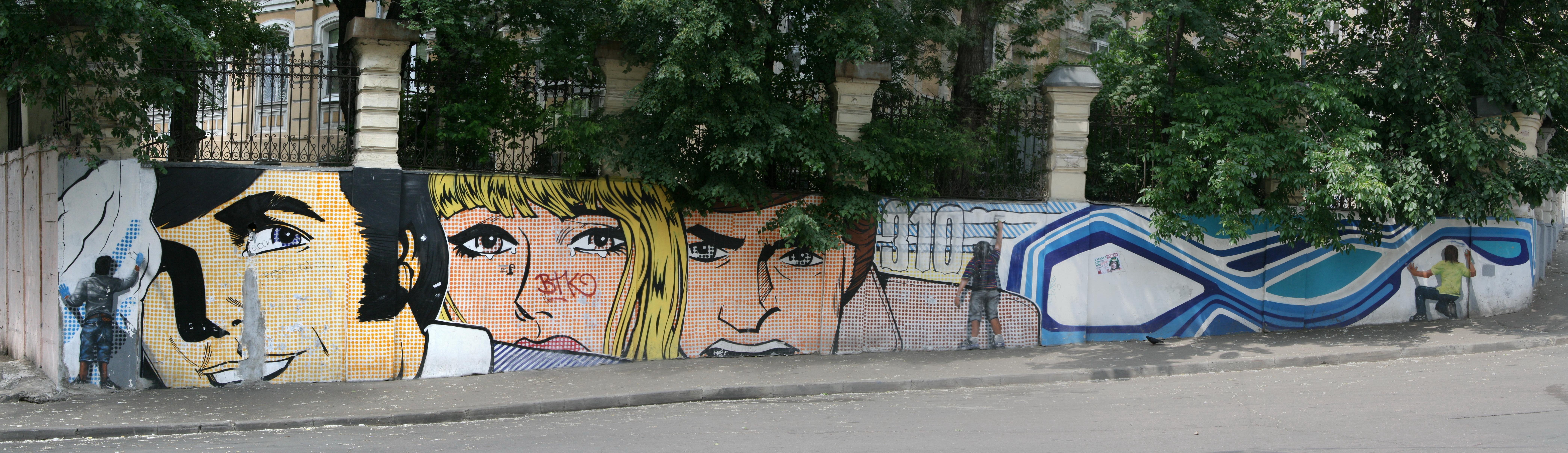Street art mural with comic faces
