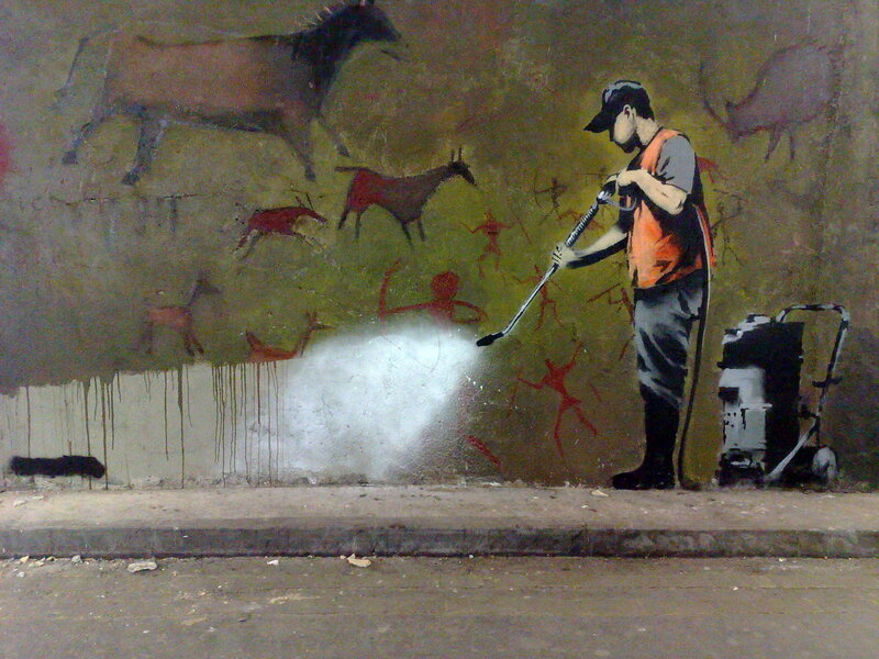 street art of worker cleaning wall
