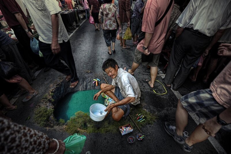 Street artist creates illusion of pond