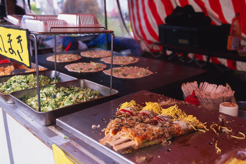 Street food vendor preparing okonomiyaki