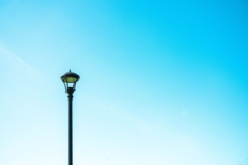 Street lamp against blue sky