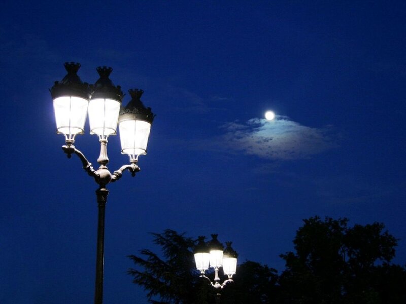 Street lamps under moonlit sky