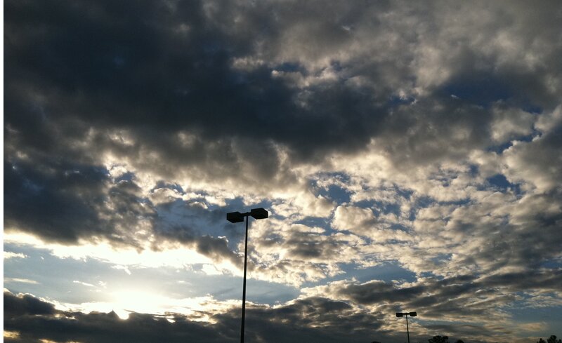 Streetlights under Cloudy Sky