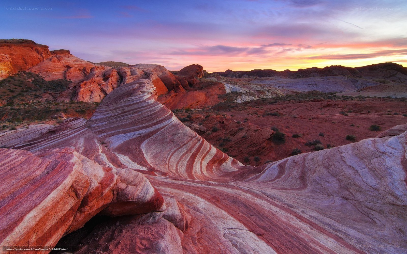 Striated rock formations at sunset