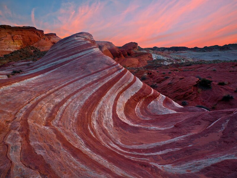 Striated rock formations at sunset