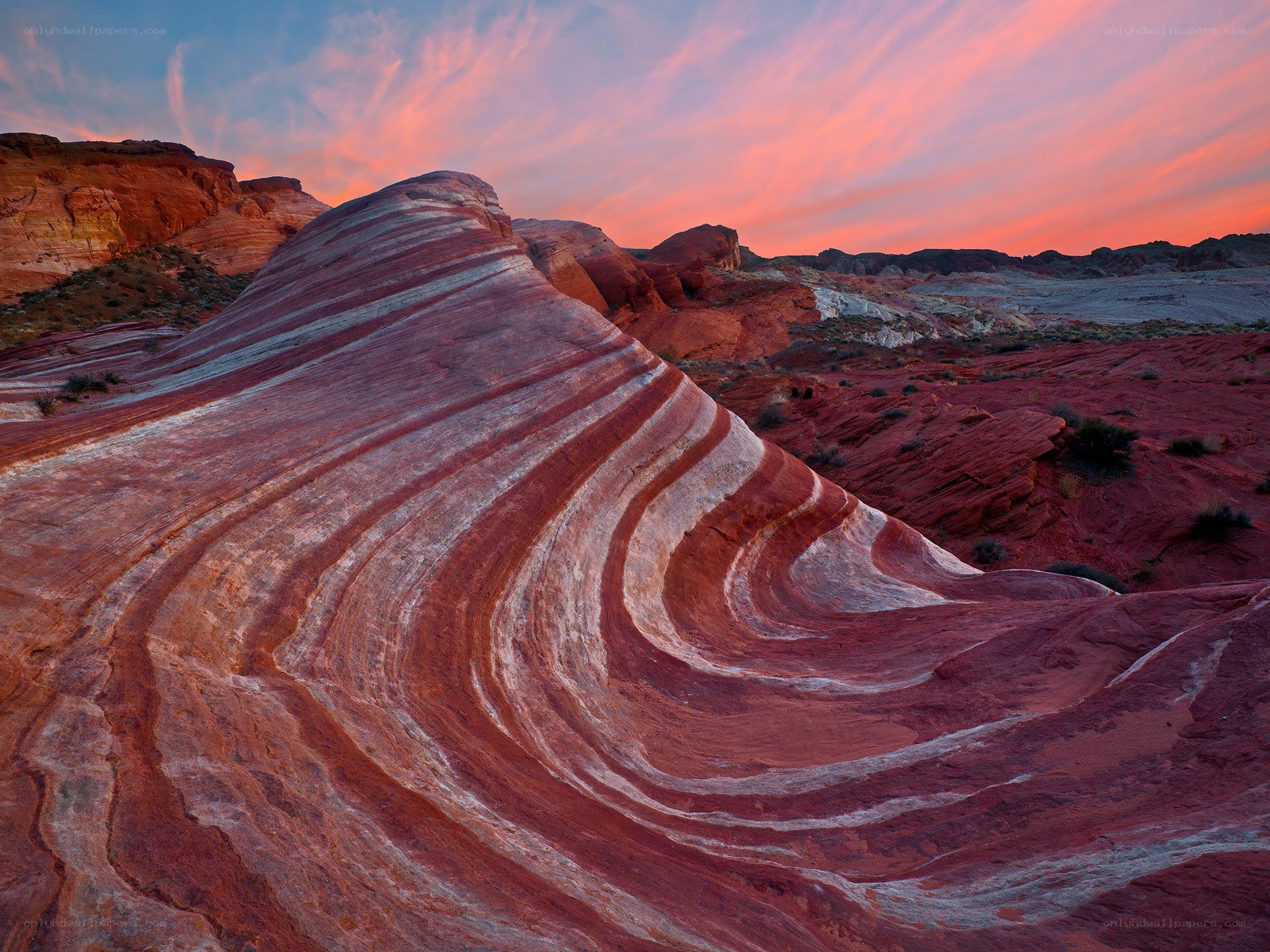 Striated rock formations at sunset
